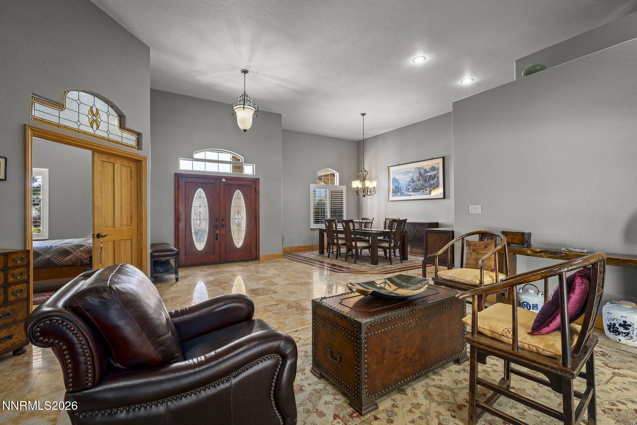 14501 Quail Rock Court Reno, NV 89511 - Photo 8 of 42 a living room with furniture a fireplace and a chandelier