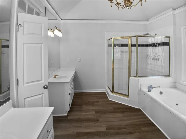 a view of a bathroom with a bathtub a sink and mirror
