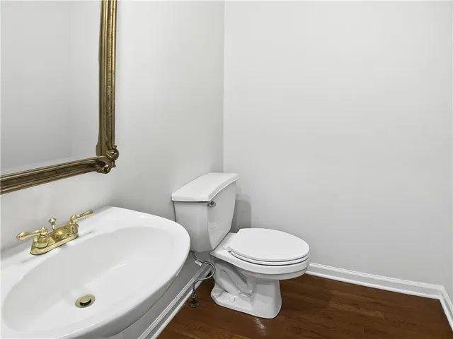 a white toilet sitting next to a bathroom sink