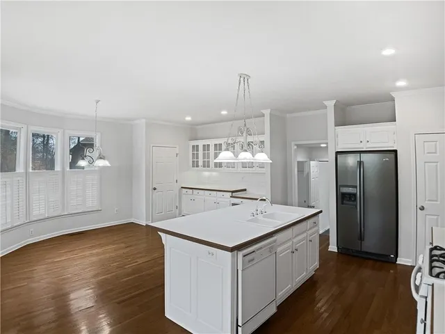 a kitchen with a sink a refrigerator and a stove