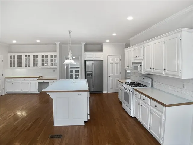 a kitchen with stainless steel appliances granite countertop a stove and a refrigerator