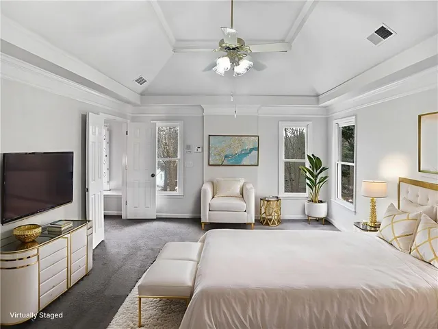 a bedroom with a large bed and a flat screen tv