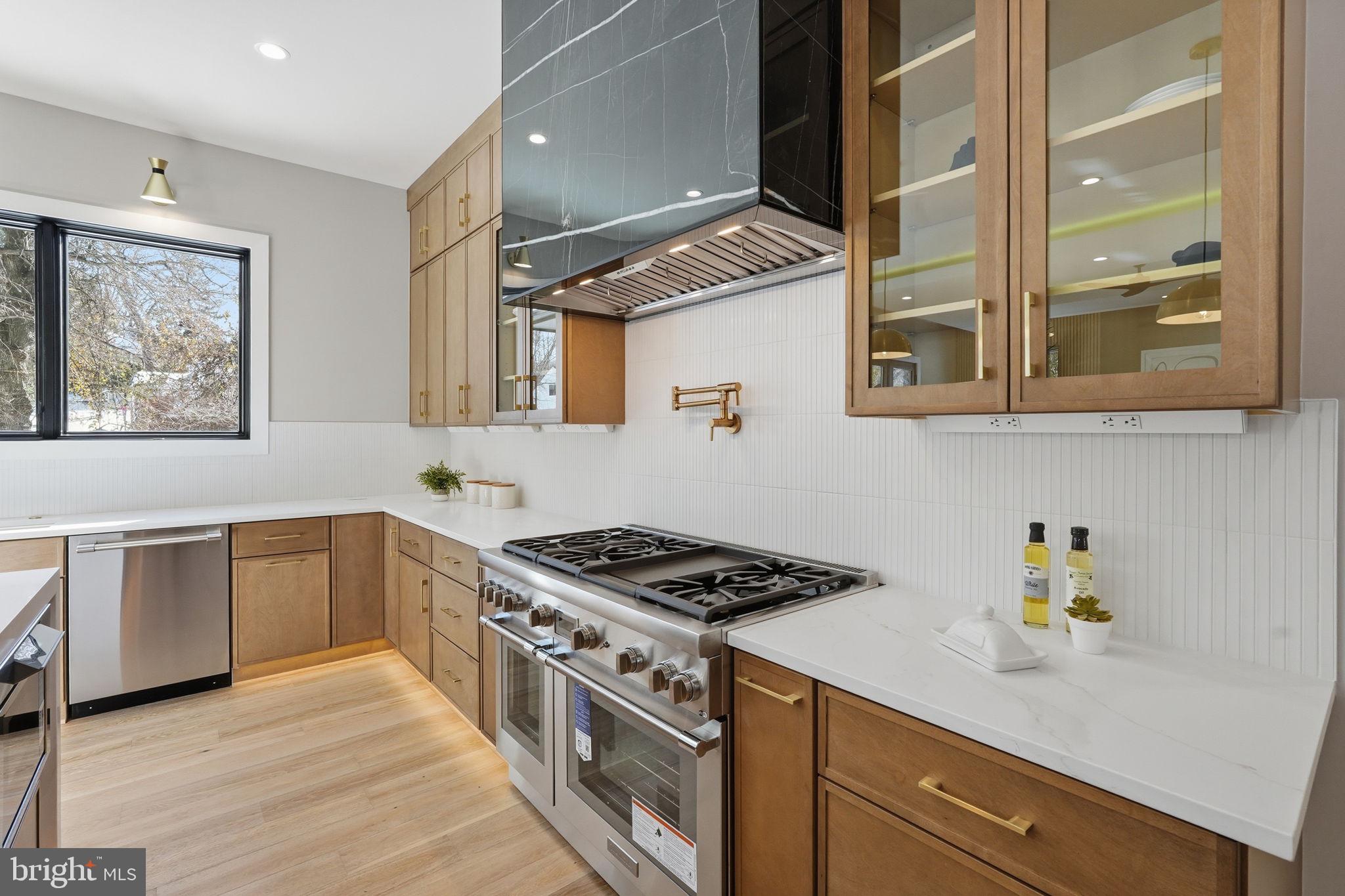 2202 Grayson Place Falls Church, VA 22043 - Photo 15 of 77 a kitchen with stainless steel appliances granite countertop a stove and a sink