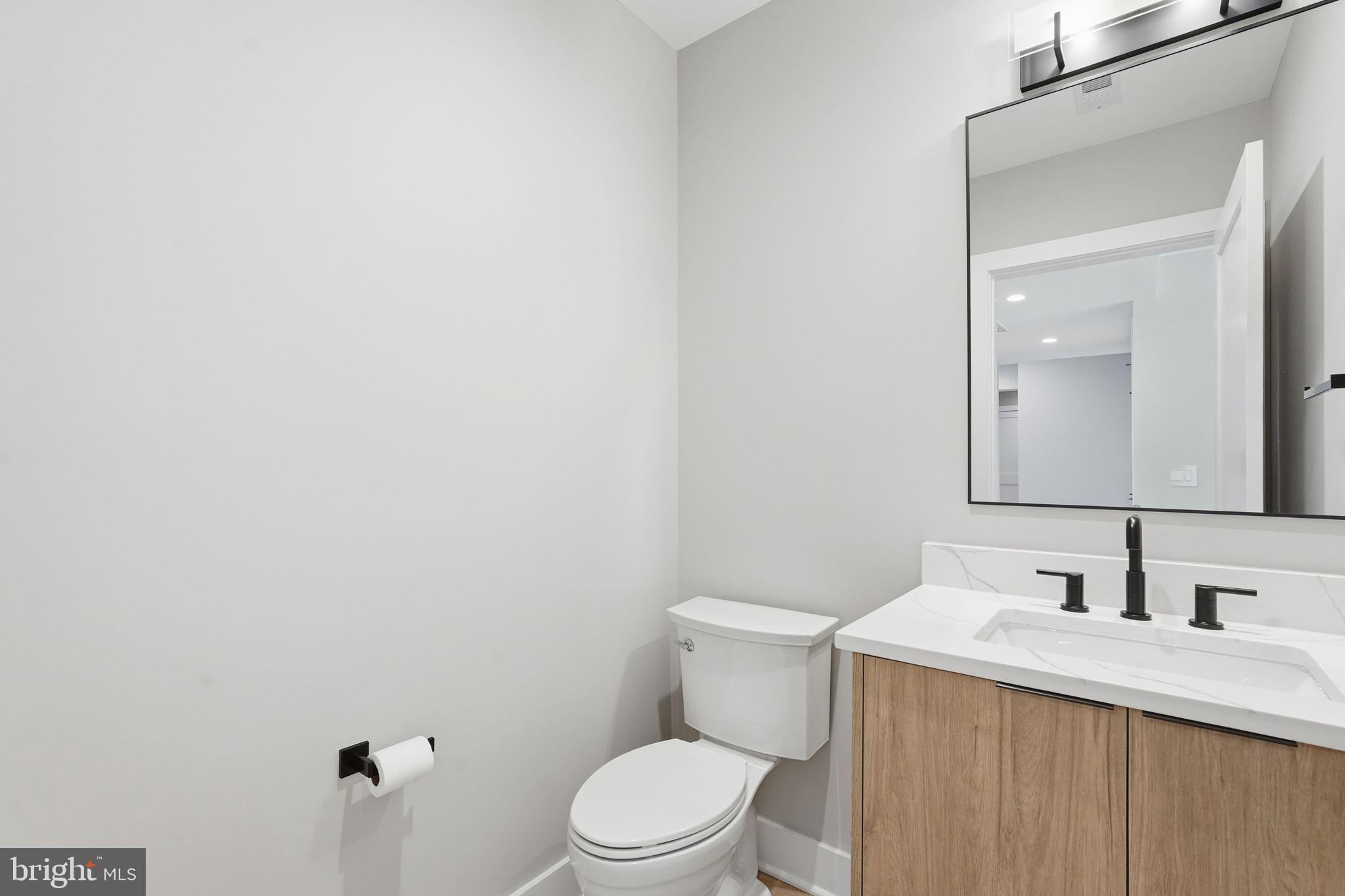 2202 Grayson Place Falls Church, VA 22043 - Photo 54 of 77 a bathroom with a granite countertop sink vanity mirror and toilet