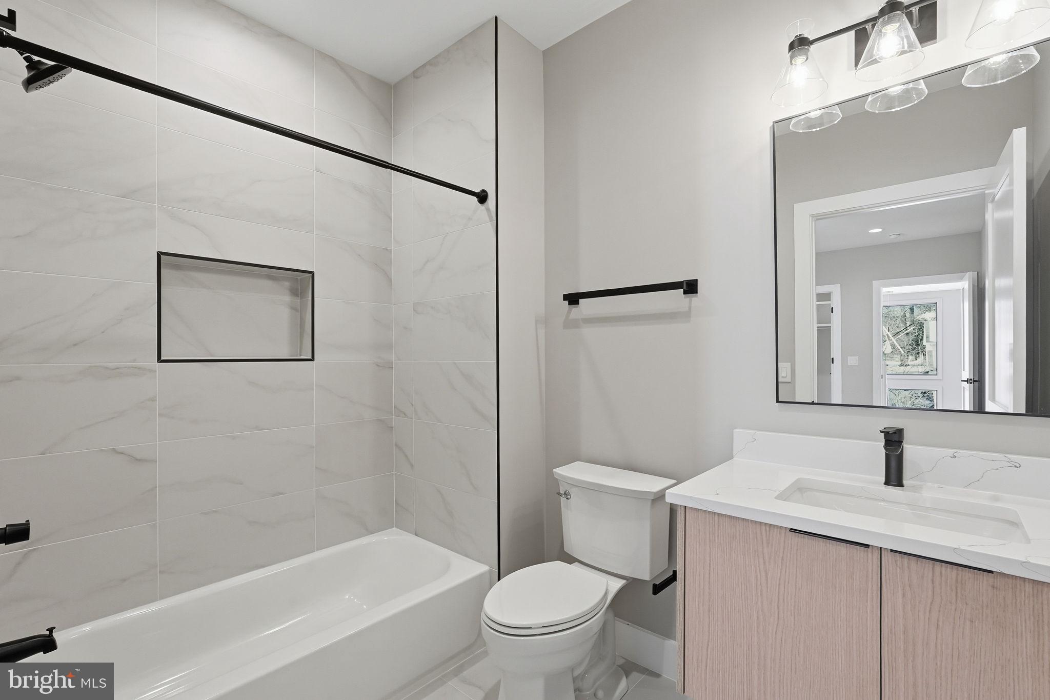 2202 Grayson Place Falls Church, VA 22043 - Photo 56 of 77 a bathroom with a granite countertop sink a toilet and shower