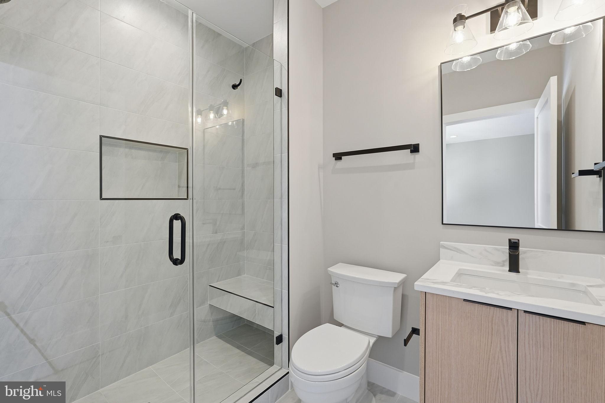 2202 Grayson Place Falls Church, VA 22043 - Photo 57 of 77 a bathroom with a shower sink vanity mirror and toilet