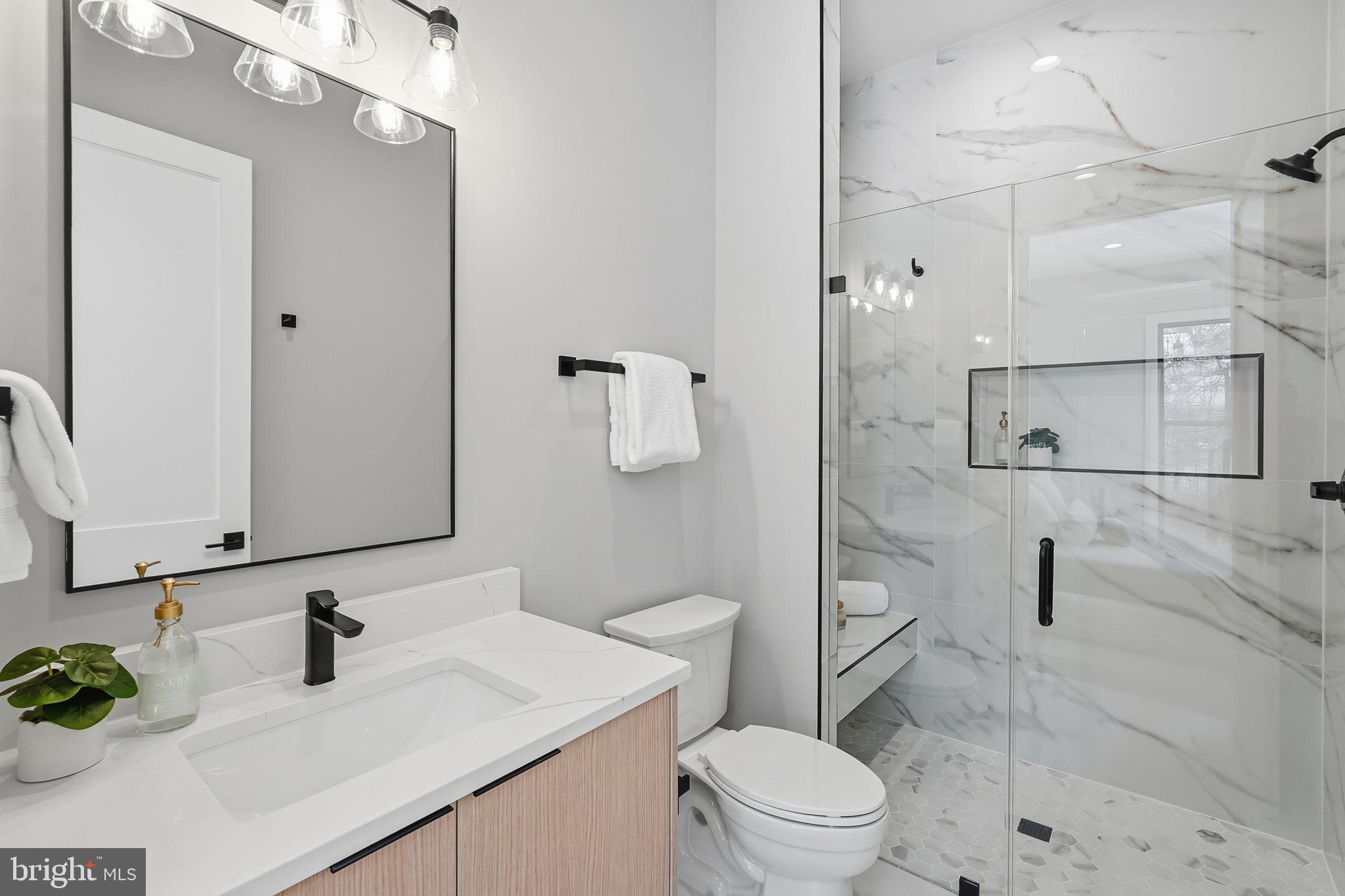 2202 Grayson Place Falls Church, VA 22043 - Photo 61 of 77 a bathroom with a sink toilet vanity and shower