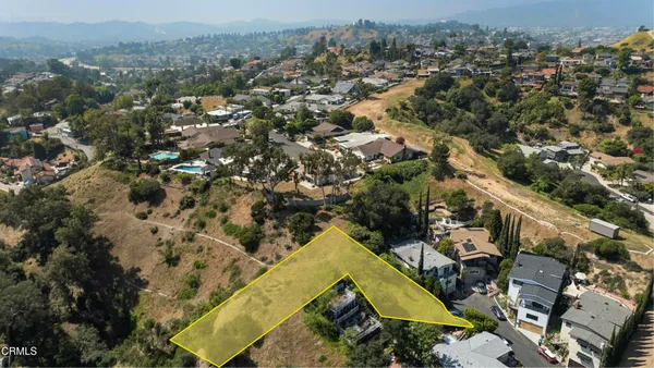 an aerial view of a residential houses with outdoor space