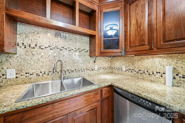 a kitchen with granite countertop stainless steel appliances sink and cabinets