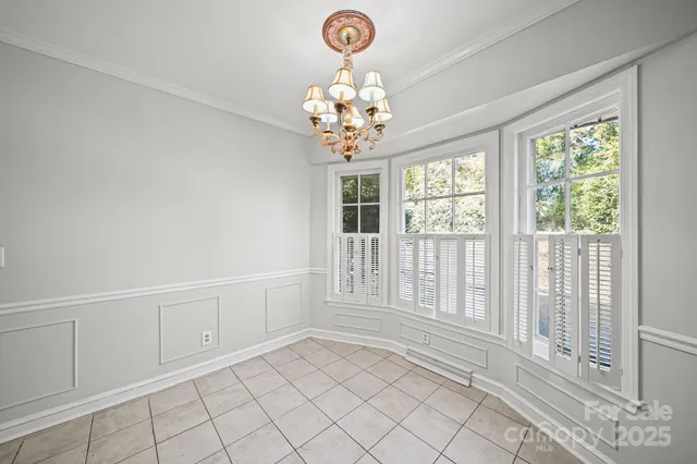 a view of an empty room with chandelier