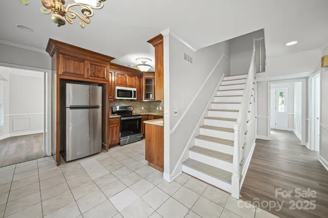 a view of a kitchen with wooden floor and electronic appliances