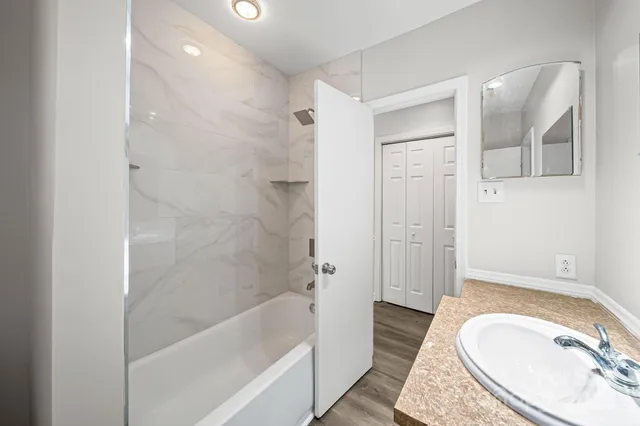 a bathroom with a sink a toilet and bathtub