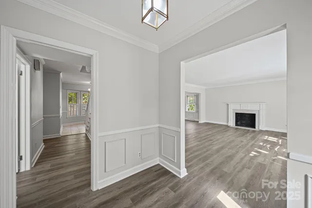 a view of a livingroom with wooden floor and a fireplace