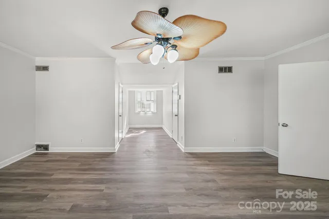 a view of an empty room and wooden floor