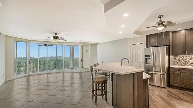 a kitchen with kitchen island granite countertop a sink a center island and cabinets