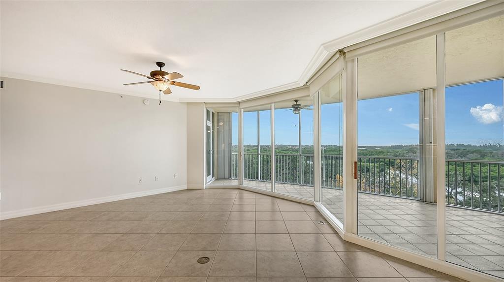 401 North Point Road, Unit 603 Osprey, FL 34229 - Photo 20 of 96 a view of an empty room with wooden floor and a window