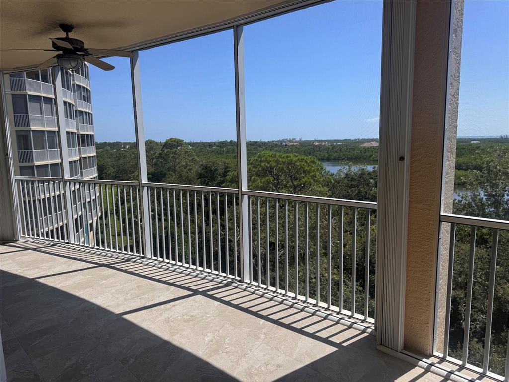 401 North Point Road, Unit 603 Osprey, FL 34229 - Photo 23 of 96 a view of a balcony with a floor to ceiling window and wooden fence