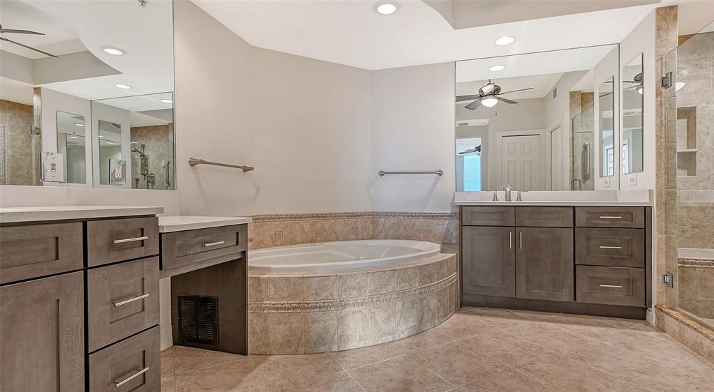 401 North Point Road, Unit 603 Osprey, FL 34229 - Photo 33 of 96 a bathroom with a tub a sink and mirror