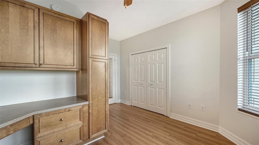 401 North Point Road, Unit 603 Osprey, FL 34229 - Photo 37 of 96 a kitchen with granite countertop wooden cabinets and a window