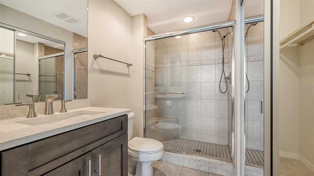 401 North Point Road, Unit 603 Osprey, FL 34229 - Photo 40 of 96 a bathroom with a shower sink vanity and toilet