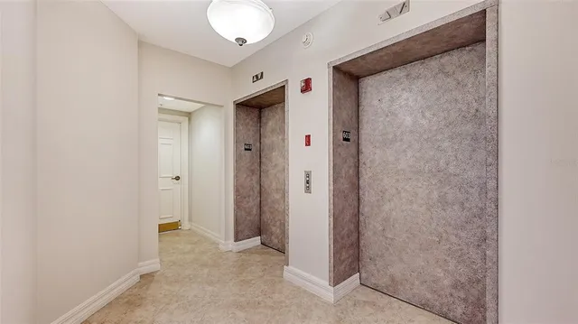 a view of a dining room with a table and chairs