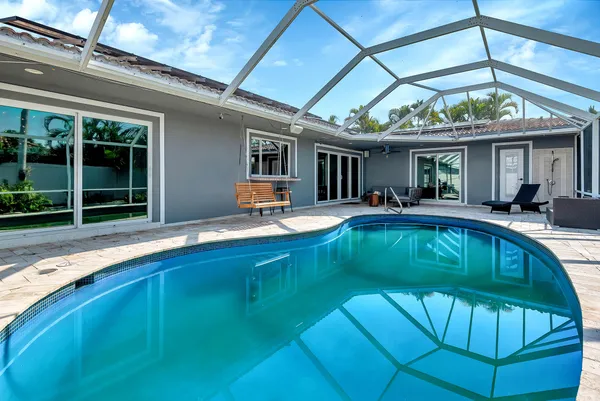 a swimming pool with outdoor seating yard and furniture