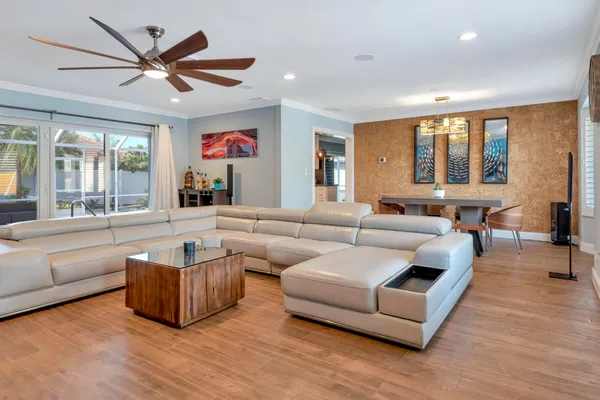 a living room with large window and a flat screen tv