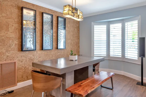 a living room with furniture a clock on wall and a window
