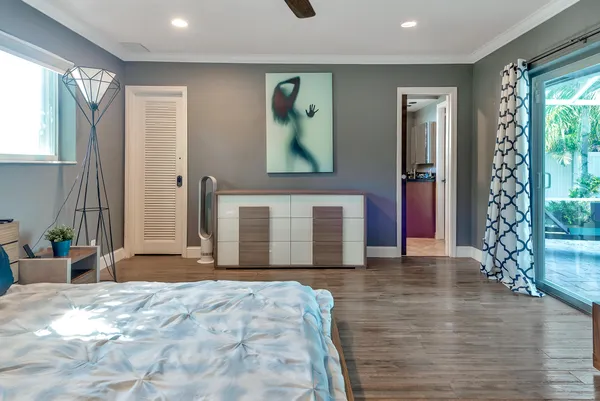 a spacious bedroom with a large bed and a chandelier