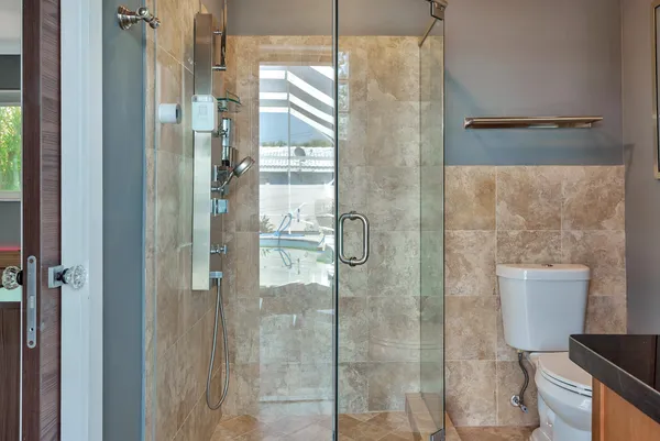 a bathroom with a toilet and a shower