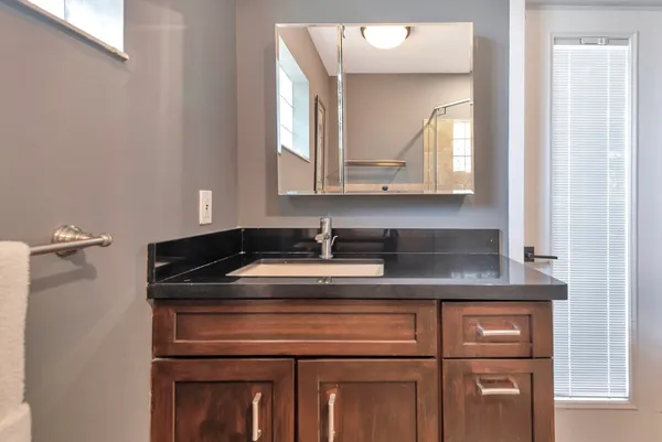 a bathroom with a granite countertop sink a toilet and bathtub