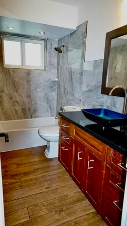a bathroom with a sink a toilet and bathtub