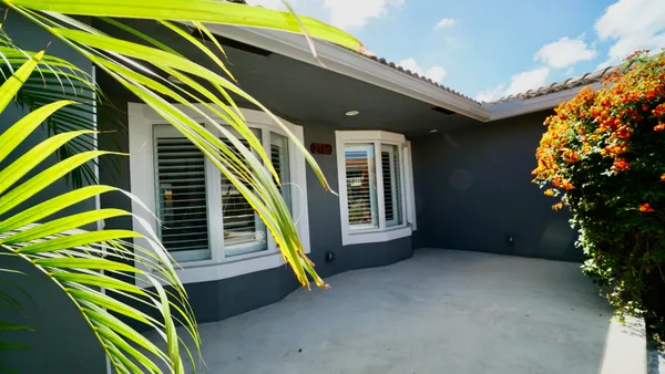 a swimming pool with outdoor seating and yard