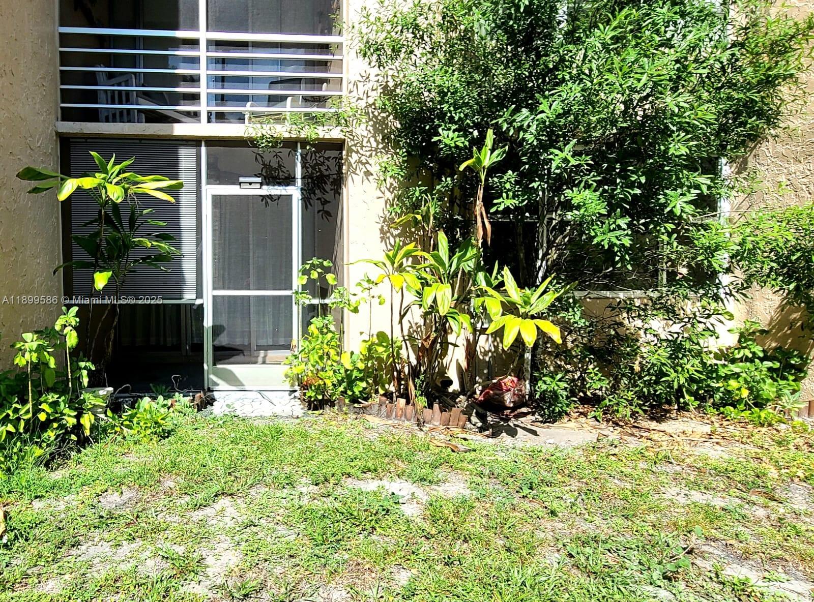 9410 Live Oak Place, Unit 109 Davie, FL 33324 - Photo 2 of 23 a plant is in front of a house