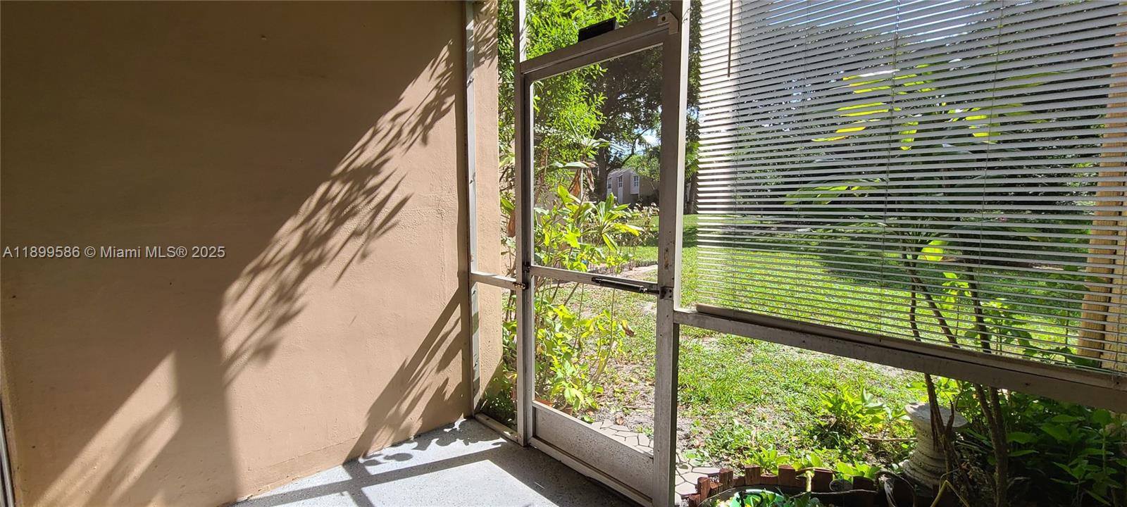 9410 Live Oak Place, Unit 109 Davie, FL 33324 - Photo 3 of 23 a view of a balcony with floor to ceiling windows with wooden floor