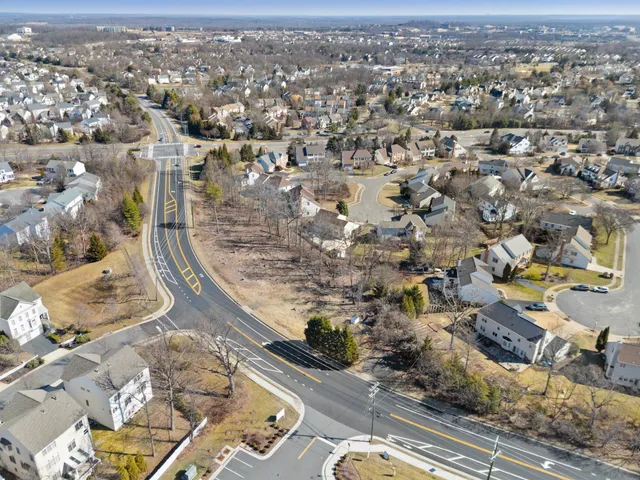 an aerial view of residential houses with city view