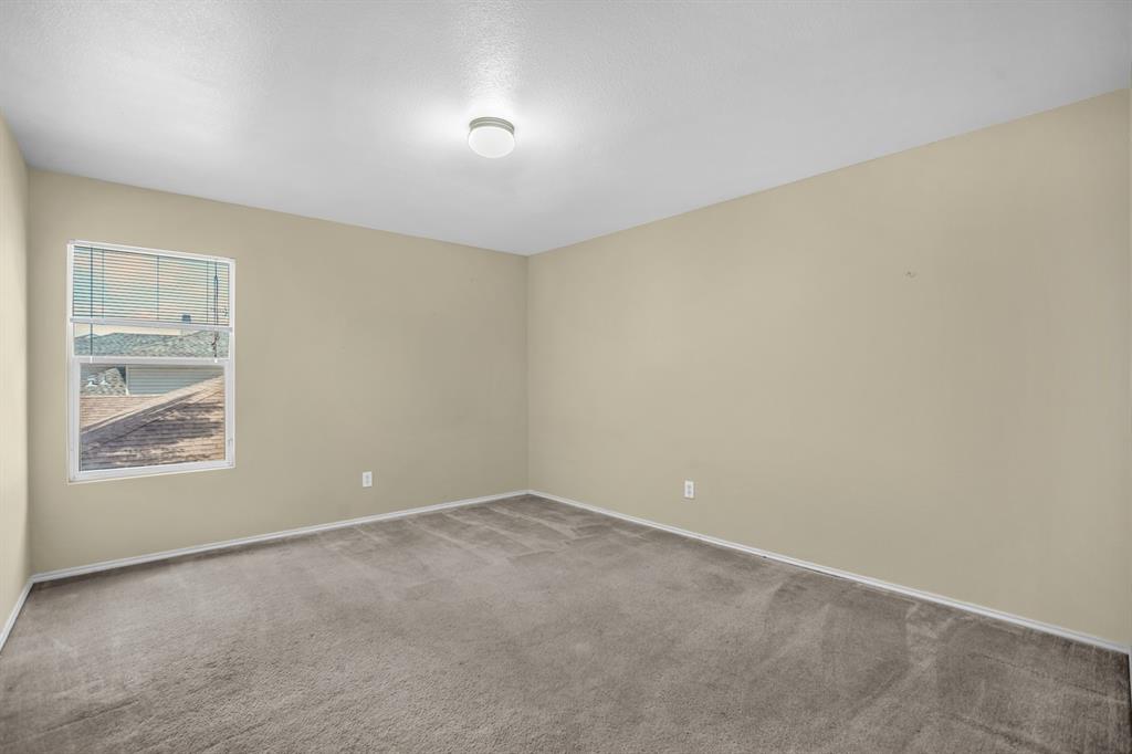 5718 Green Ivy Road Denton, TX 76210 - Photo 25 of 37 Neutral-toned walls and grey carpet flooring define this interior space
