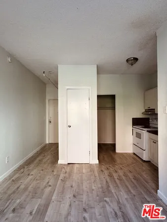 a view of a kitchen with a sink and a refrigerator