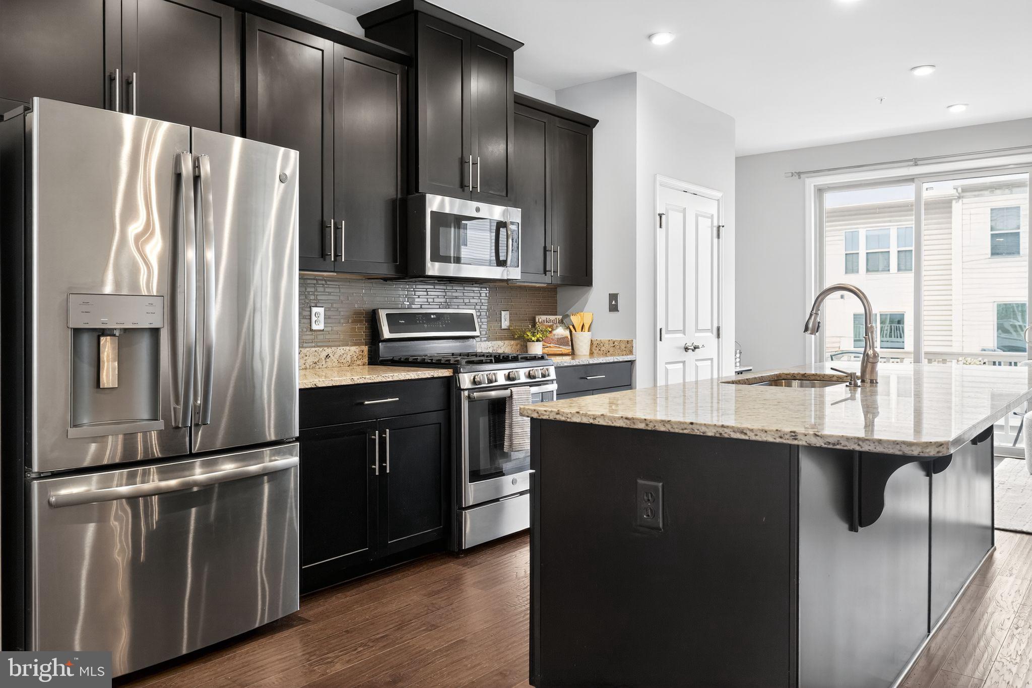 3637 Jamison Street Northeast Washington, DC 20018 - Photo 11 of 44 a kitchen with stainless steel appliances a refrigerator sink and stove