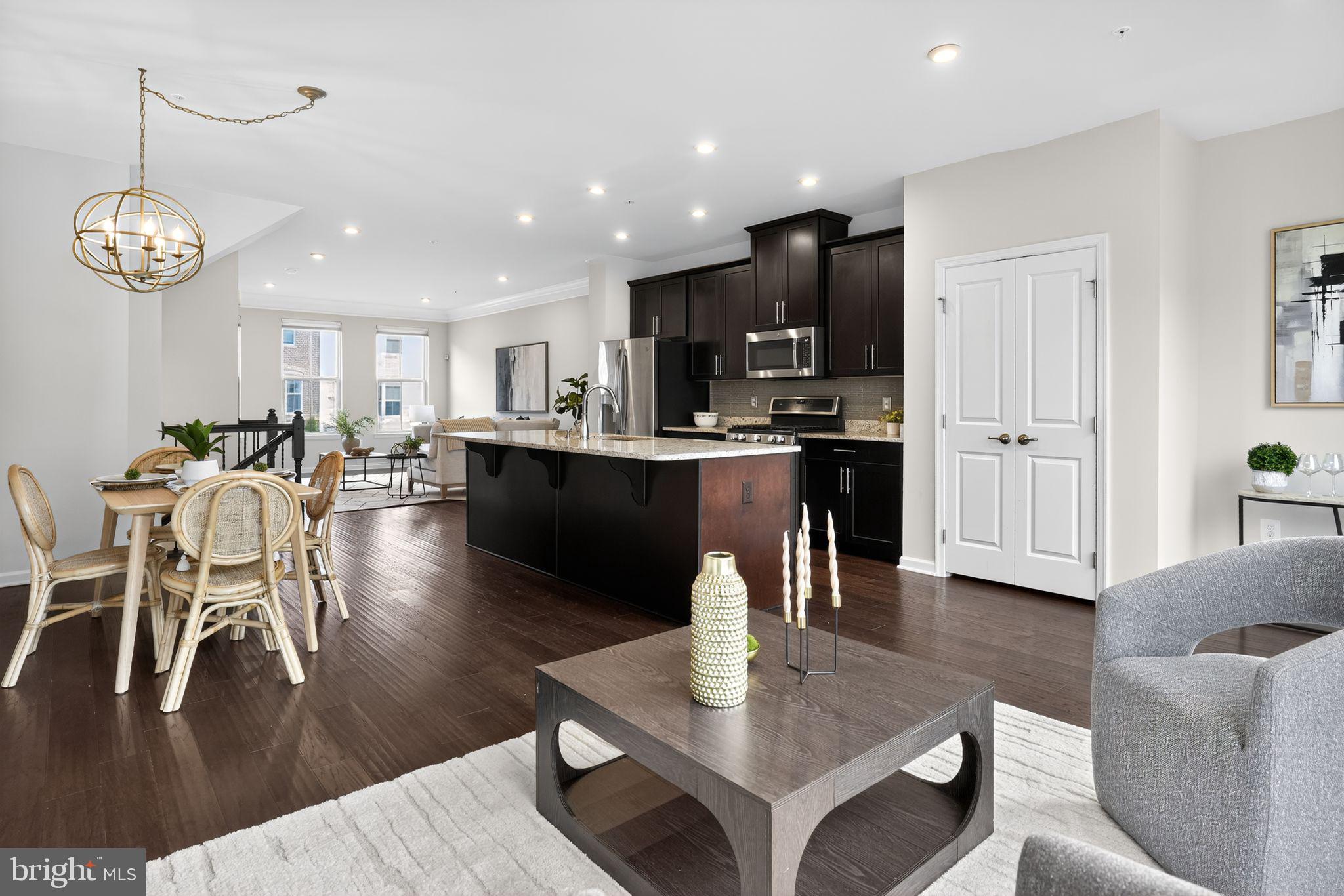 3637 Jamison Street Northeast Washington, DC 20018 - Photo 2 of 44 a living room with stainless steel appliances kitchen island granite countertop furniture a rug kitchen view and a chandelier