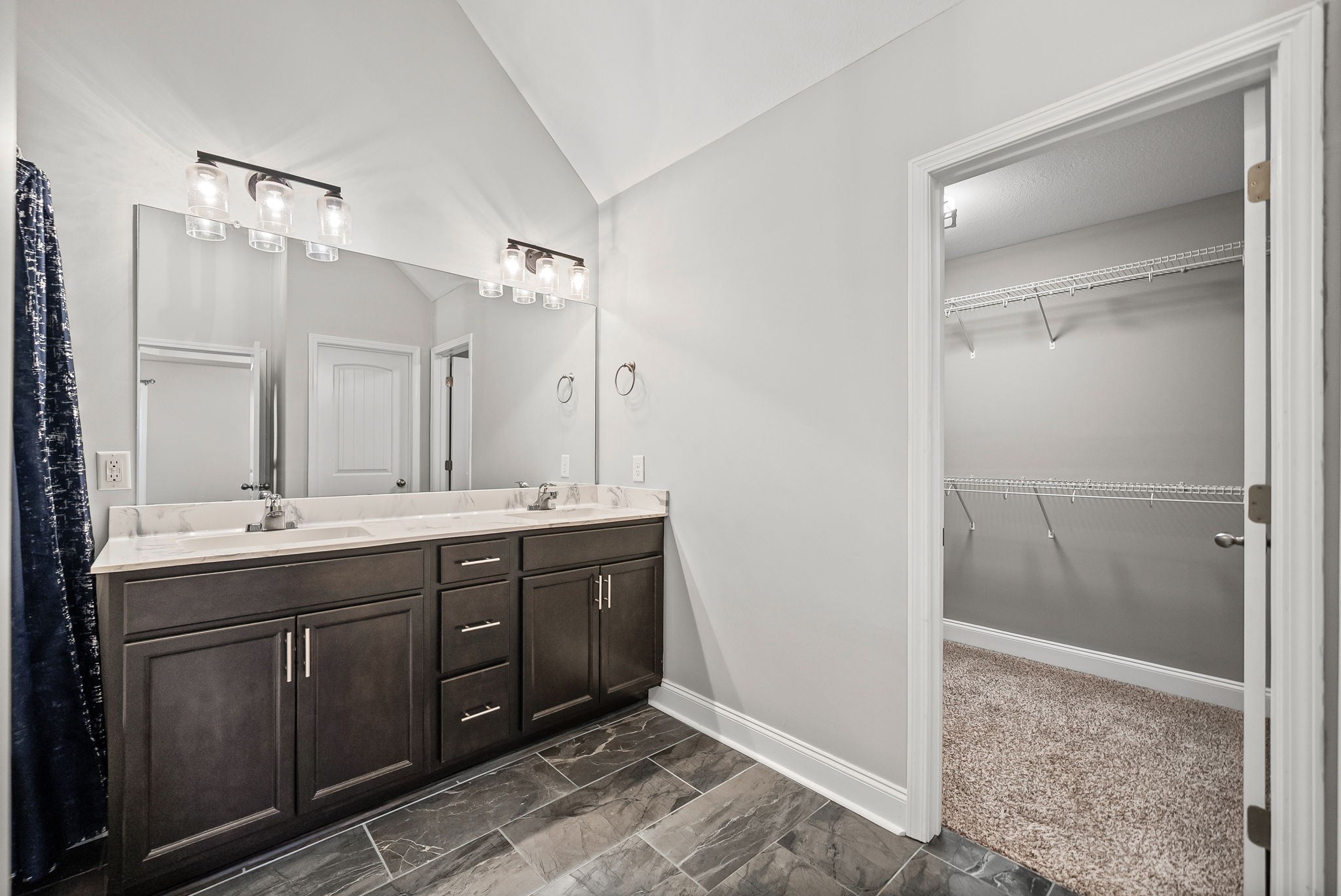 1796 Rains Road Clarksville, TN 37042 - Photo 18 of 26 a spacious bathroom with a shower sink and mirror