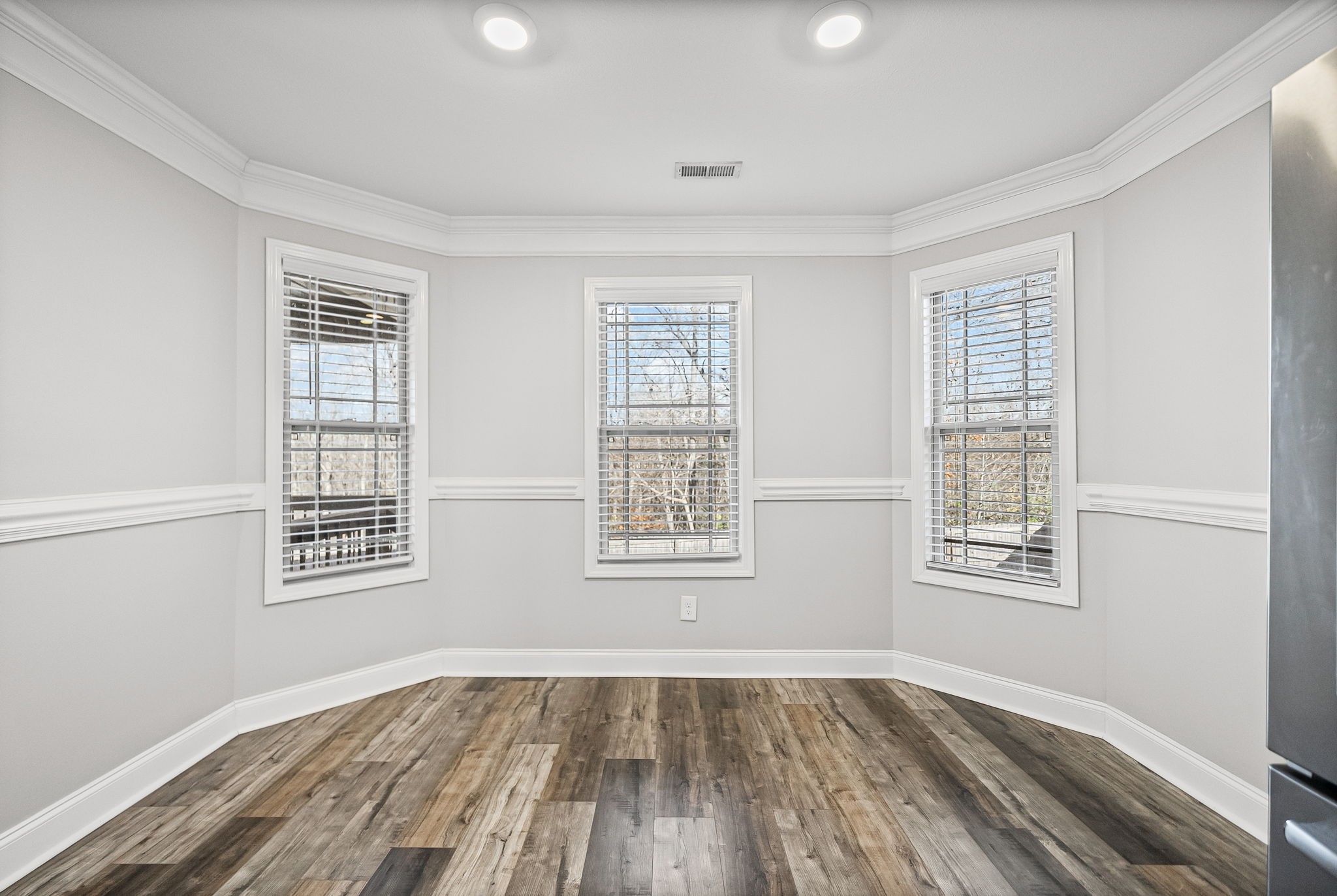 1796 Rains Road Clarksville, TN 37042 - Photo 9 of 26 a view of an empty room with wooden floor and a window
