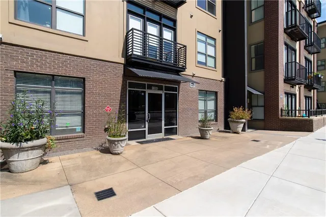 a view of a brick house with potted plants
