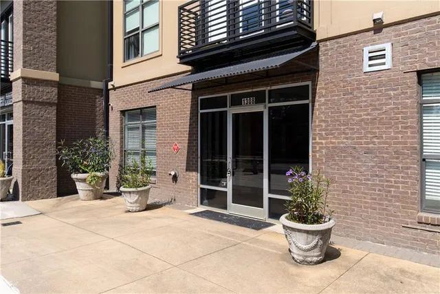 a view of a house with potted plants