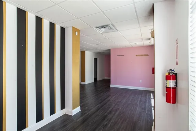 a view of a hallway with wooden floor and entryway