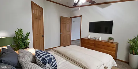 a bedroom with a bed and a flat screen tv