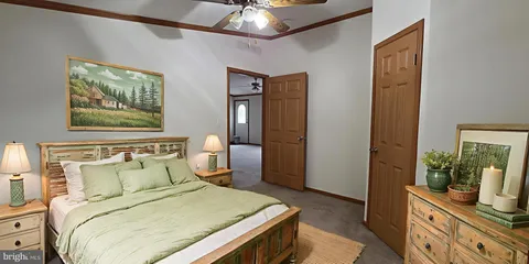 a bedroom with a bed and a mirror on the dresser