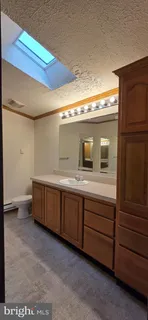 a bathroom with a double vanity sink and mirror