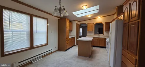 a view of a hallway with couch and chandelier