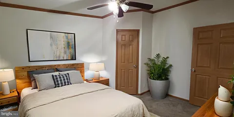 a bedroom with a bed and a potted plant